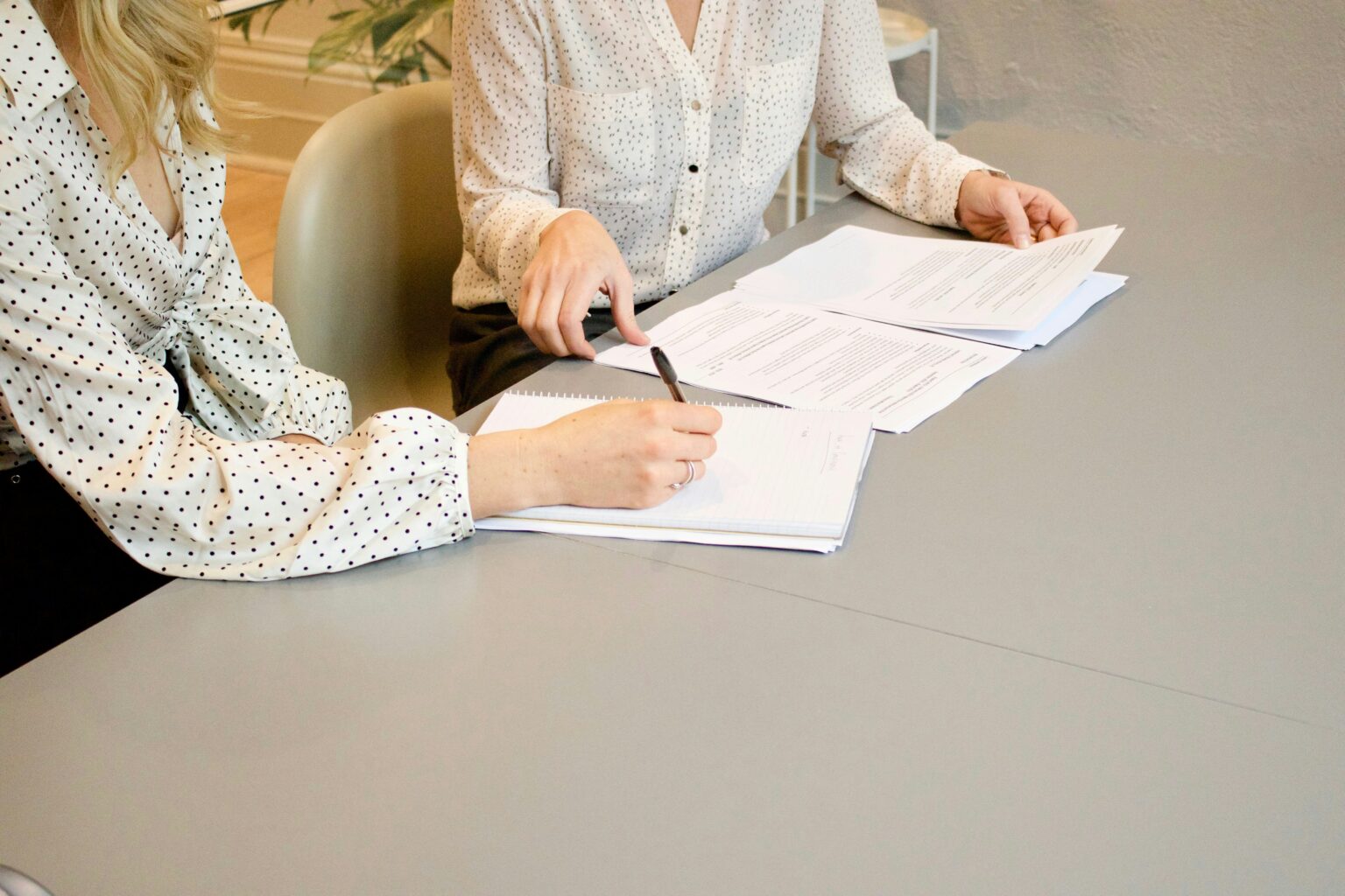 Two businesswomen comparing documents